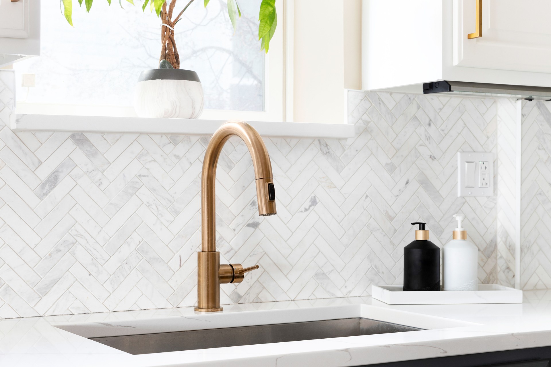 A gold kitchen sink detail shot in a beautiful kitchen.